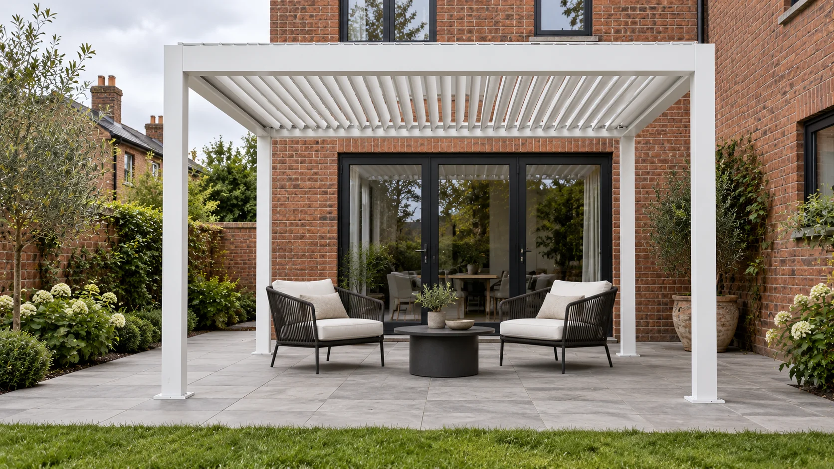 Pergola LUMINA bianca nel patio di una casa in mattoni